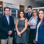 A group of people standing in front of some cabinets